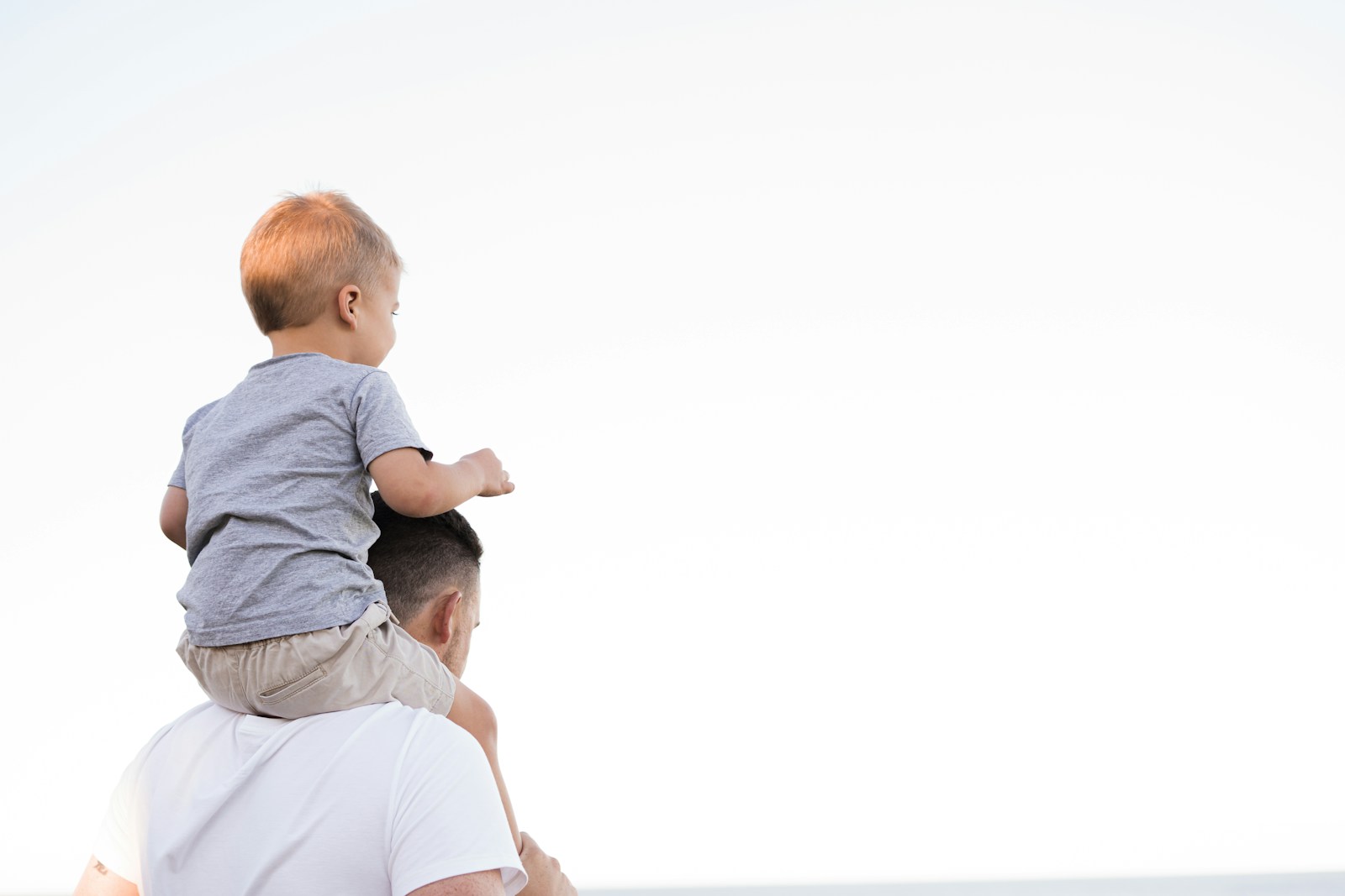 man in white shirt carrying boy, life insurance