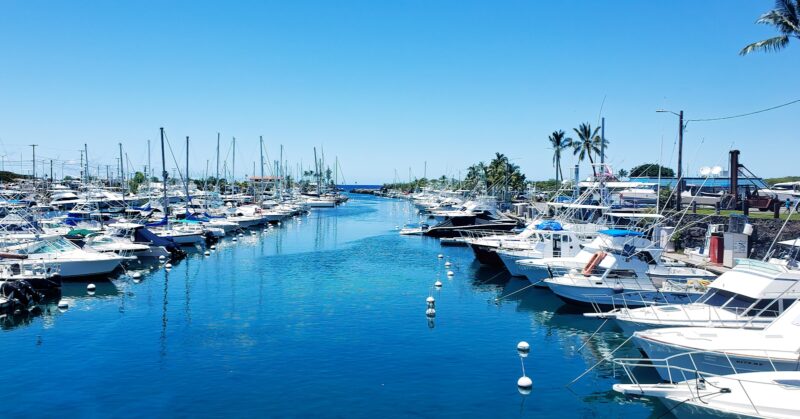 white boats on sea dock during daytime